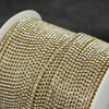 Taśma ozdobna cyrkoniowa gold/crystal 2mm [50cm]
