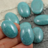 Kaboszon szklany Opaque Turquoise - Blue Luster owal 25x18mm