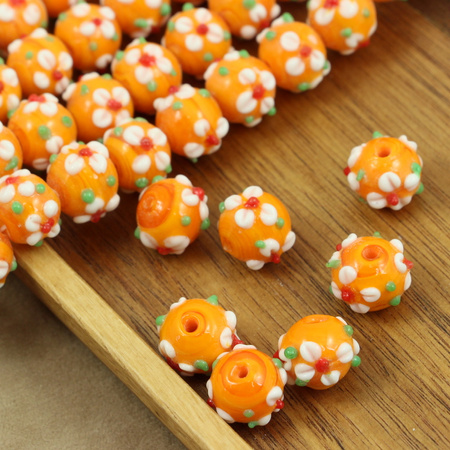 Koralik szklany w kwiatki pomarańczowy 13x12mm
