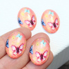 Kaboszon szklany z motylem owal łososiowy 25x18mm