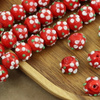 Koralik szklany w kwiatki czerwony 13x12mm