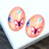 Kaboszon szklany z motylem owal łososiowy 25x18mm