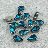 Kaboszon w oprawie łezka fasetowana teal 13x8mm